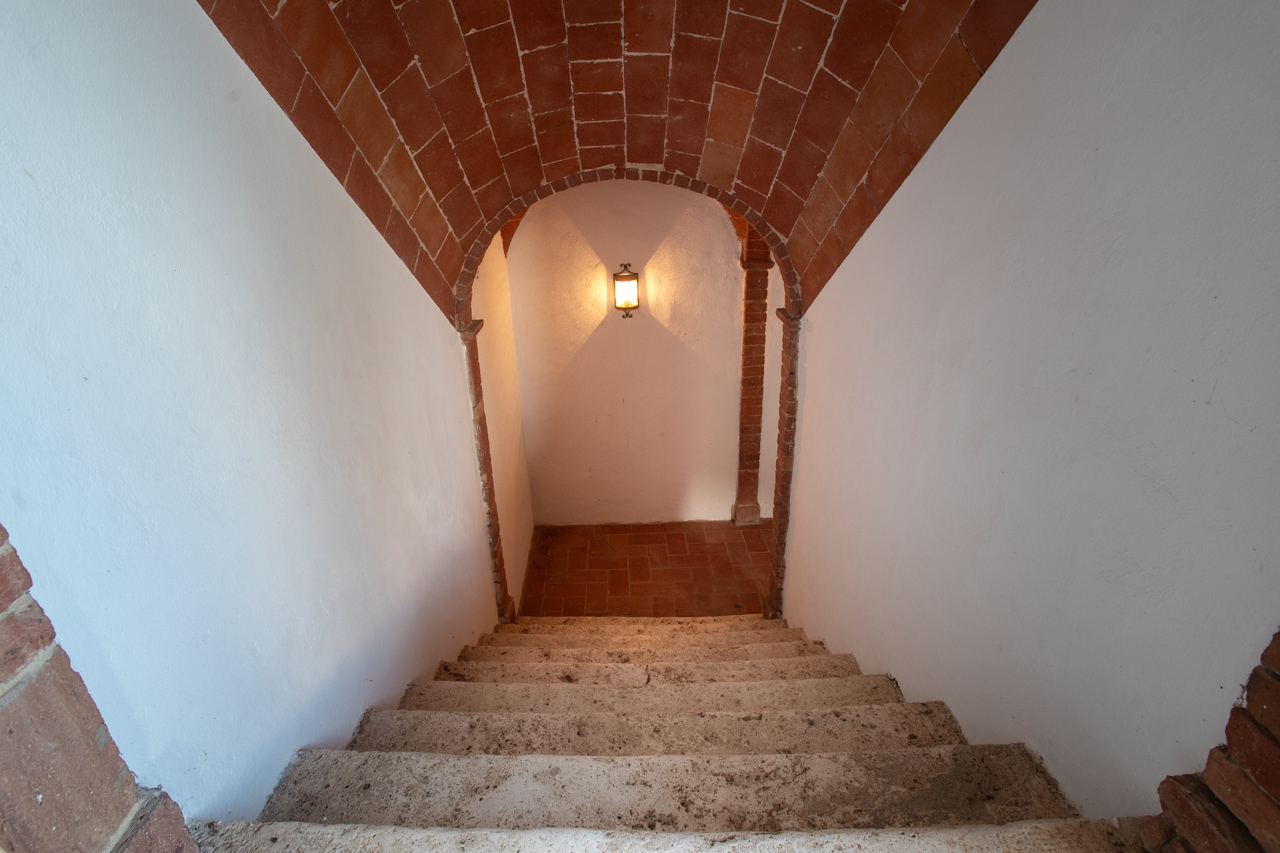Historic stone staircase with brick arch and lantern